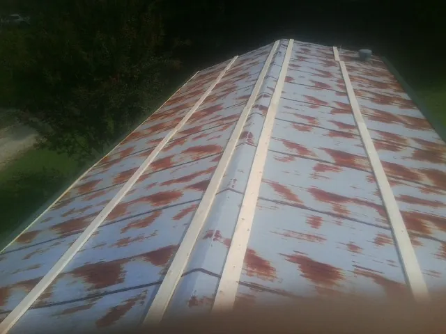 Rusted metal roof panels with new wood purlins before replacement — Storm Damage Roof Repair in Hooversville by Roofing Brothers