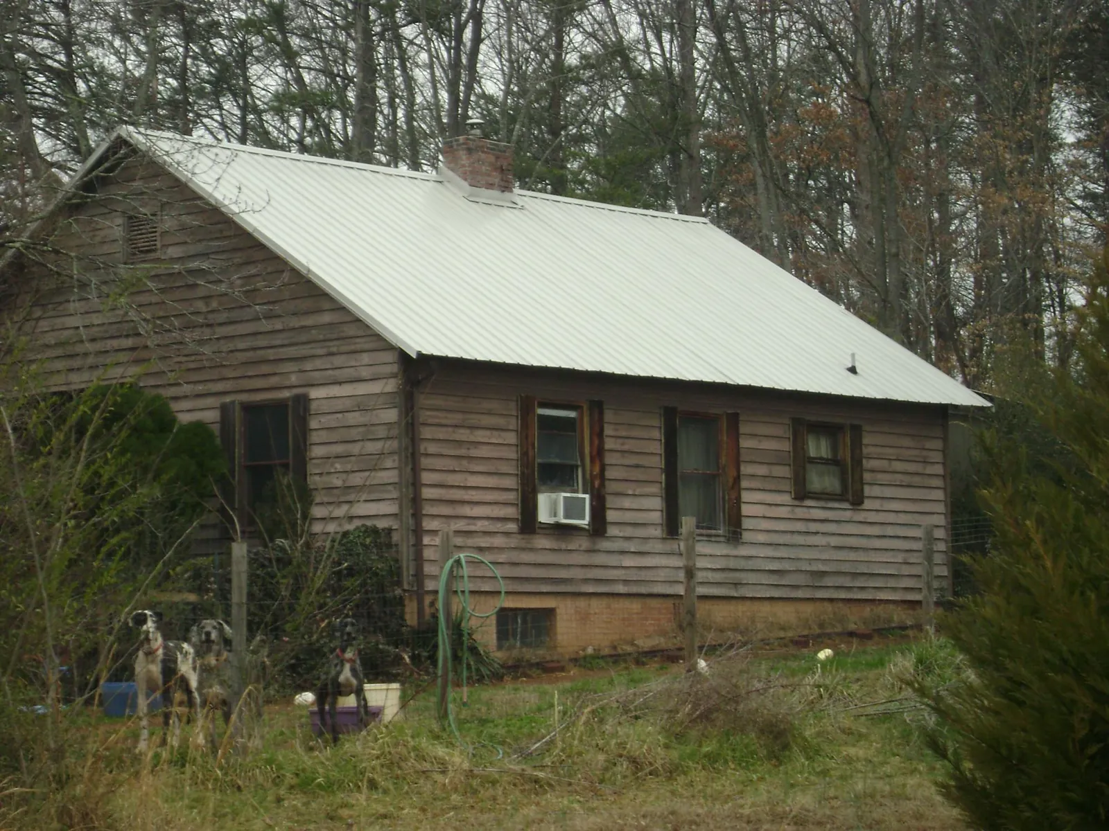 White metal roof on an old wood sided farmhouse, from a Metal Roof Installation job in Hooversville